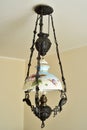 Antique chandelier with iron construction and lampshade with floral motif