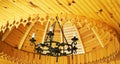 Antique chandelier and wooden ceiling. Royalty Free Stock Photo