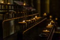 Candelabra with candles lit and half-extinguished that are offerings left by the religious faithful.