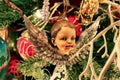 Antique cherub on old fashioned Christmas tre