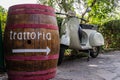 An antique Chianti wine barrel and a vespa scooter