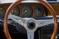 Antique classic wood steering wheel and dashboard in German vintage car Royalty Free Stock Photo