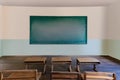 Antique classroom in school with Rows of empty wooden desks