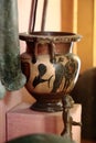 Antique clay black-figure krater with images of a winged dolphin and people, among other exhibits, close-up