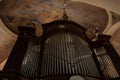 a clock on top of a pipe organ in a church