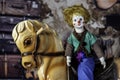 antique clown doll on vintage hobby horse