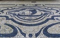 Antique cobblestone mosaic with a ship on a shopping street Rua de Sampaio Bruno sidewalk in old town of Porto, Portugal