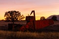 Antique combine and tractor in field with sunset Royalty Free Stock Photo