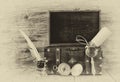 Antique compass, inkwell and old wooden chest on wooden table. black and white style old photo Royalty Free Stock Photo