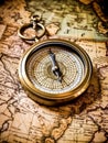 An antique compass placed on a vintage map Royalty Free Stock Photo