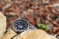 Antique compass on rock