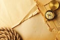 Antique compass and rope over old map Royalty Free Stock Photo