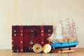 Antique compass, wooden boat and old chest on wooden table