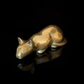 Vintage gold figurine of a cat on a black isolated background