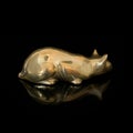 Vintage gold figurine of a cat on a black isolated background