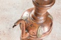 Antique copper jug with lid on concret background Royalty Free Stock Photo