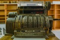 Antique crank-operated cash register, old metal.