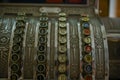 Antique crank-operated cash register, old metal.