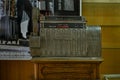 Antique crank-operated cash register, old metal.