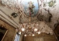 Antique crystal chandelier in a frescoed room