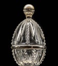 Antique crystal glassware for a chicken egg with a pearl lid on a black background