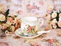 Antique cup of tea with saucer ,yellow orange rose flowers background ,porcelain vintage style ,old English coffee cup still life Royalty Free Stock Photo