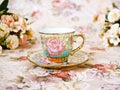 Antique cup of tea with saucer ,yellow orange rose flowers background ,porcelain vintage style ,old English coffee cup still life Royalty Free Stock Photo