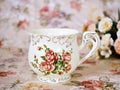 Antique cup of tea with saucer ,yellow orange rose flowers background ,porcelain vintage style ,old English coffee cup still life Royalty Free Stock Photo