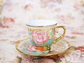 Antique cup of tea with saucer ,yellow orange rose flowers background ,porcelain vintage style ,old English coffee cup still life Royalty Free Stock Photo