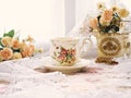 Antique cup of tea with yellow orange rose flowers background ,porcelain teacup vintage style ,old English coffee cup Royalty Free Stock Photo