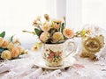 Antique cup of tea with yellow orange rose flowers background ,porcelain teacup vintage style ,old English coffee cup Royalty Free Stock Photo