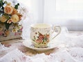 Antique cup of tea with yellow orange rose flowers background ,porcelain teacup vintage style ,old English coffee cup Royalty Free Stock Photo