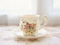 Antique cup of tea with yellow orange rose flowers background ,porcelain teacup vintage style ,old English coffee cup Royalty Free Stock Photo