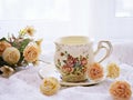 Antique cup of tea with yellow orange rose flowers background ,porcelain teacup vintage style ,old English coffee cup Royalty Free Stock Photo