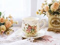 Antique cup of tea with yellow orange rose flowers background ,porcelain teacup vintage style ,old English coffee cup Royalty Free Stock Photo