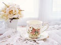 Antique cup of tea with yellow orange rose flowers background ,porcelain teacup vintage style ,old English coffee cup Royalty Free Stock Photo