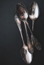 Antique cutlery on black background. Silver spoons isolated. Silverware with copy space. Silver cutlery. Stylish retro utensil. Royalty Free Stock Photo