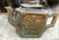 Antique decoration peice old tea pot with blur background with buddah engraved on front side Royalty Free Stock Photo