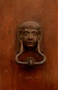 Antique decorative brass door knocker in the shape of egyptian f Royalty Free Stock Photo