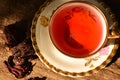 Antique and delicate cup with hibiscus tea on rustic background Royalty Free Stock Photo