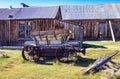 Antique discarded and abandoned Horse Drawn Wagon and Wood Building. Royalty Free Stock Photo
