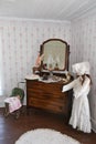 Antique doll carriage and mannequin in an old fashioned bedroom