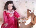 Antique Doll with her Sewing Machine