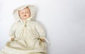 Antique Doll in Knit Sweater with Cameo on White Background Royalty Free Stock Photo