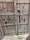 An antique door dating back to an old house containing inscriptions and decoration