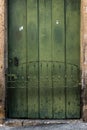 Antique door details in color with shadow, iron, cement, wood