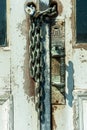 Antique door handle up close with chains and padlock