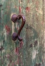 Antique door handle and wooden door. The paint on the door cracked and peeled off. Royalty Free Stock Photo