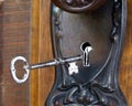 Antique door with skeleton key going into key hole Royalty Free Stock Photo