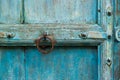 Antique Doorknob on the Aged and Rustic Blue Wooden Door Royalty Free Stock Photo